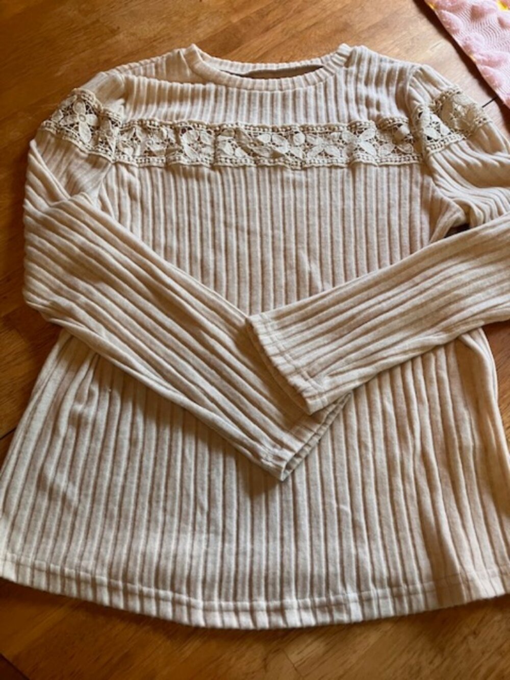 Cream colored top with lacy detail on top